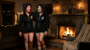 Friends in matching house rompers by the fire